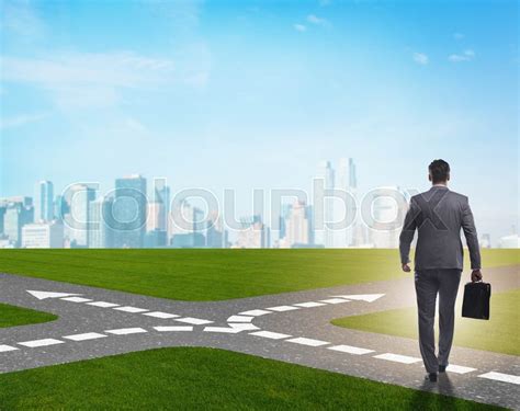 The Young Businessman At Crossroads In Stock Image Colourbox