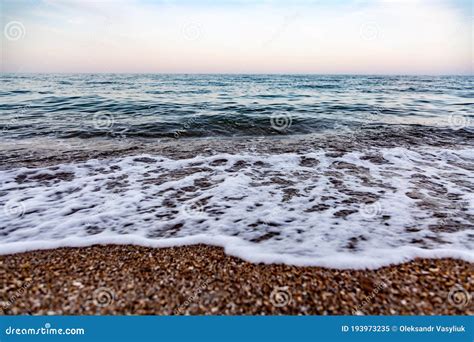 The Calm Sea Waves Against The Pebble Shore Close Up Horizon