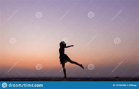 Silhouette Of Woman Dancing At Sunset Stock Photo Image