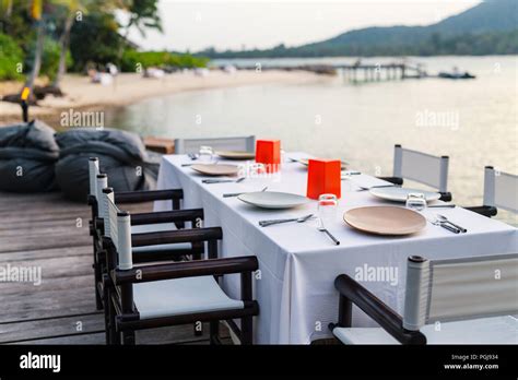 Romantic Luxury Dinner Setting At Tropical Resort On Sunset Stock Photo