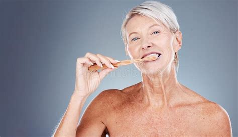 Brushing Teeth Portrait And Senior Woman In Studio For Dental Mouth