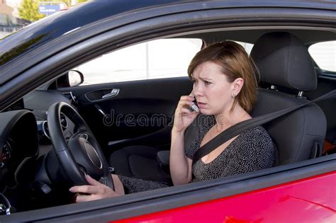 Worried And Stressed Woman Driving Car While Talking On The Mobile