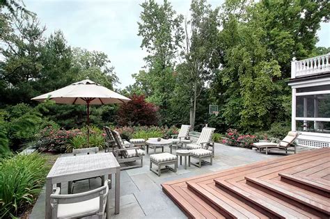 Large Patio Area Featuring An Outdoor Living Set And A Small Dining