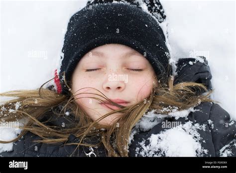 Girl Lying In Snow Stock Photo Alamy