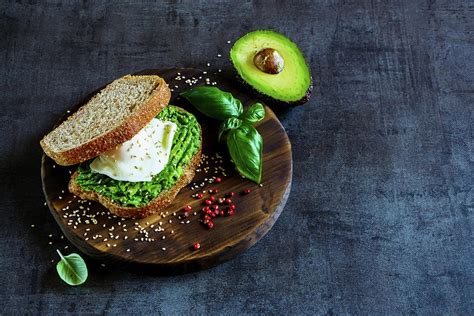 Healthy Avocado And Poached Egg Sandwich With Sesame Seeds Photograph