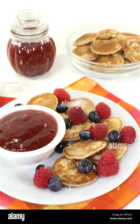 Dutch Poffertjes With Berries And Jelly Before Light Background Stock