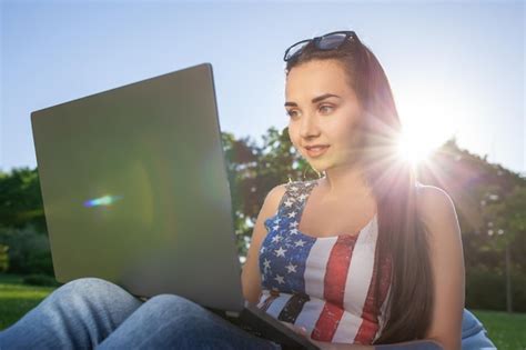 Premium Photo Pretty Young Woman Sitting On Bean Bag Use Laptop While