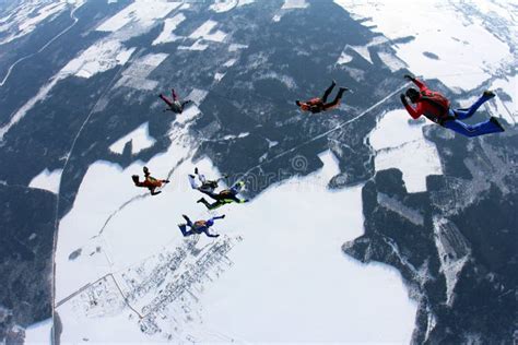 Formation Skydiving In The Winter Sky Above Snowy Fields Editorial