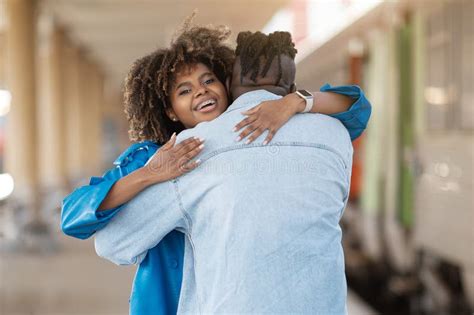 Happy Young Black Woman Hugging Her Boyfriend After Reunion At Railway