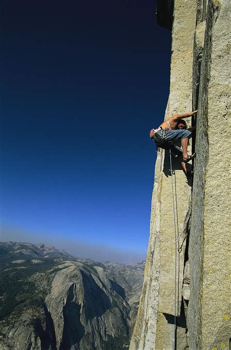 a man climbing half dome yosemite photograph by jimmy chin