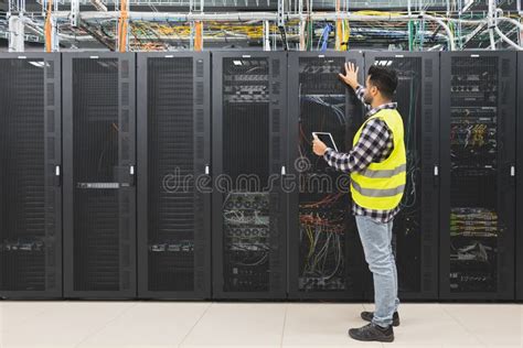 Male Informatic Engineer Working In Server Room Database Stock Image