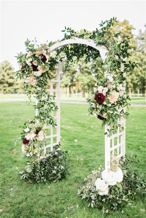White Wedding Arch Decorated With Greenery Roses Hydrangeas