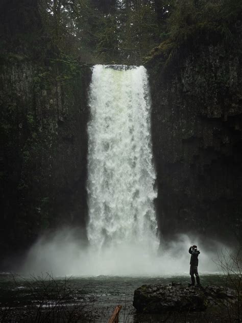Photo Of Person Standing Near Waterfalls · Free Stock Photo