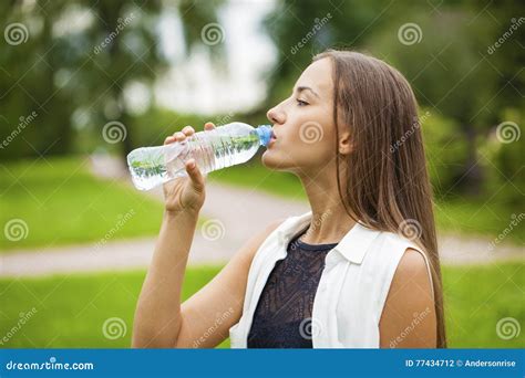 Portrait Of Young Beautiful Dark Haired Woman Drinking Water Stock