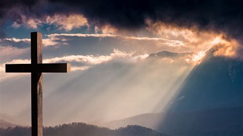 Jesus Christ Wooden Cross On A Dramatic Colorful Sunset Stock Photo