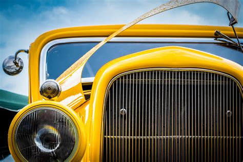Front View Of The Yellow Oldtimer Vintage Car Headlight Grille And An