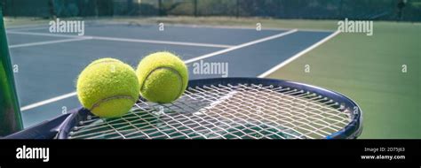 Tennis Court Panorama Background With Blue Racket And Two Tennis Balls