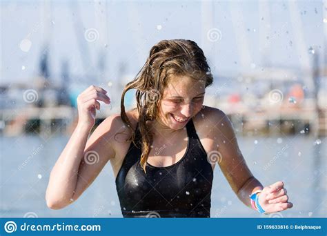 Beautiful Jolly Young Teen Girl Enjoys Water And Summer Vacation In
