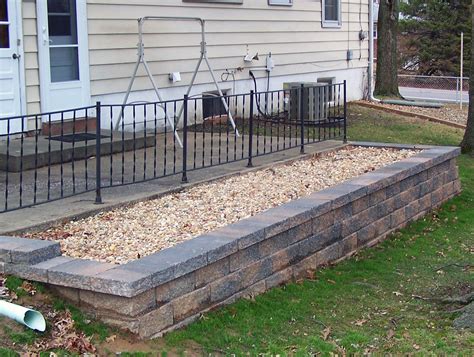 Covering a cinder block wall helps it fit the aesthetic of the surrounding buildings and improves its durability. Block Retaining Walls - Landscaping St. Louis, Landscape ...