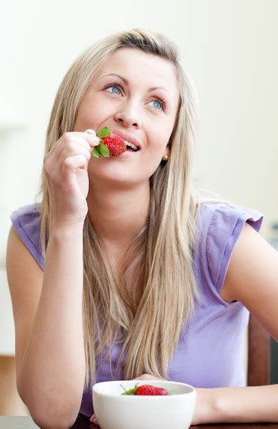 Premium Photo Portrait Of A Beautiful Woman Eating A Strawberry