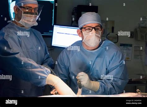 Appendix Removal Surgery Surgeon Teaching A Surgical Resident To Use A