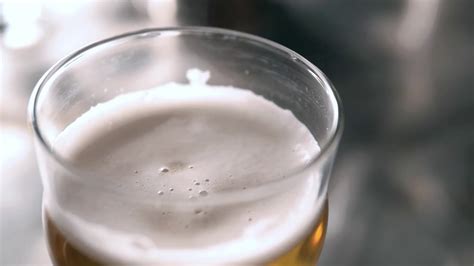 Beer Into Glass With A Lot Of Bubles And Foam Super Close Up Slow