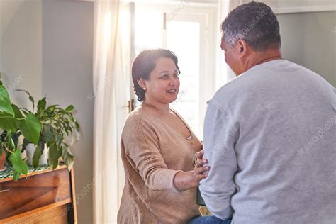 Mature Wife Talking And Comforting Husband At Home Stock Image F031