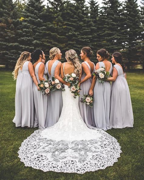 A Group Of Bridesmaids Standing In The Grass