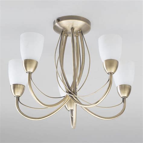 The globe shaped milk glass shades are ideal for illuminating your entryway, hall or living room while adding a modern appeal. Madrid 5 Light Semi Flush Ceiling Light - Antique Brass ...