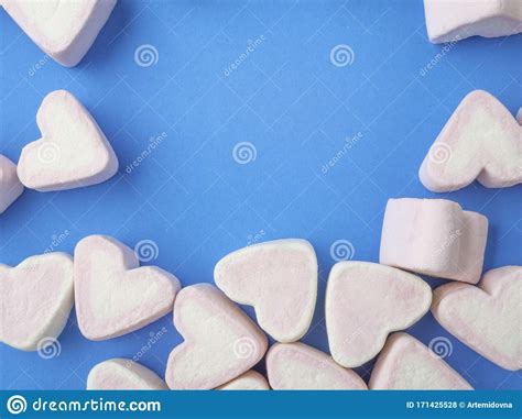 Pink Marshmallow In Heart Shape Stacked On Blue Wood Table With Copy
