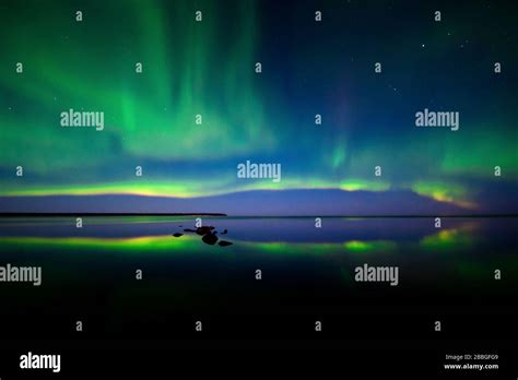 Aurora Dancing Over Water In Lake Winnipeg Manitoba Canada Stock Photo