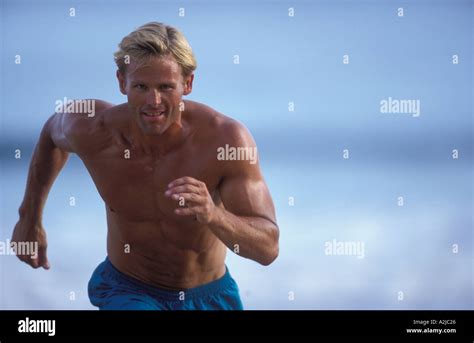 Physically Fit Shirtless Man Running Towards The Camera Stock Photo Alamy