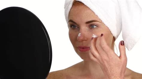 Woman Applying Cream On Face Close Up Slow Motion Stock Footage