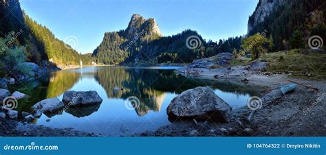 Idyllic Autumn Scene In The Alps With Mountain Lake Reflection Stock