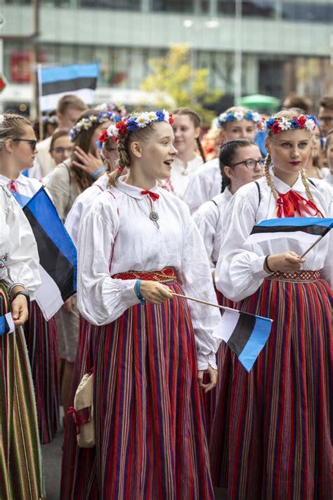 Estonian People In Traditional Clothing Walking The Streets Of Tallinn