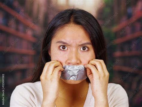 Young Brunette Woman Wearing White Sweater Gagged With Duct Tape