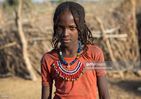 Portrait Of An Afar Tribe Girl With Braided Hair And Beaded Necklace