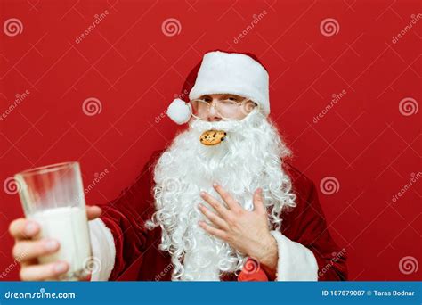 Close Up Portrait Of A Funny Santa Claus Eating A Delicious Christmas