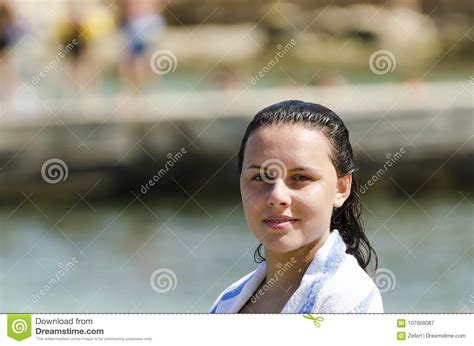 Portrait Of Girl Smiling On The Beach Wrapped In A Towel Stock Image