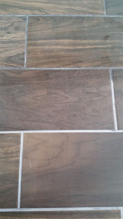 Skip scrubbing tiles and use grout pen to paint and recolor your grout for a bright clean appearance. White film on new grout???
