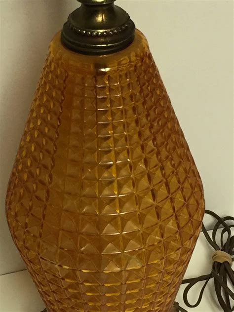 Mid Century Hollywood Regency Diamond Cut Amber Glass Table Lamp With A Footed Brass Tone Base