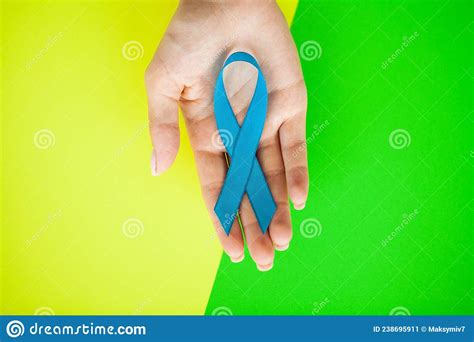 Male Hand Holding Blue Prostate Cancer Awareness Ribbon Stock Image