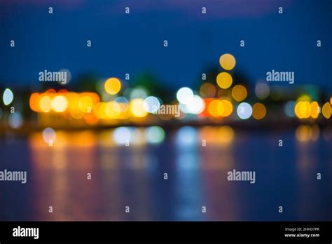 Beautiful Blurred City Lights With Bokeh Effect Reflected On Water