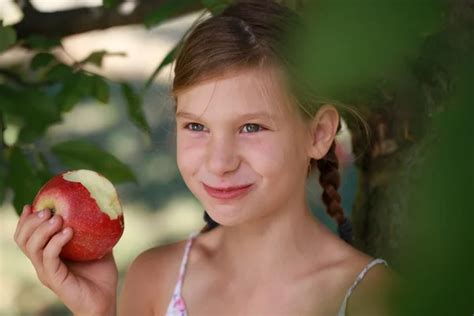 Young Girl Eating An Apple Stock Photo By ©boarding2now 15363287