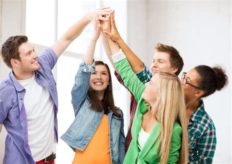 Happy Students Giving High Five At School Stock Photo Image Of Hands