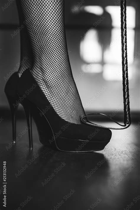 Dominant Woman In Black Fishnet Stockings And High Heels With Riding Crop Bdsm Beautiful Slim