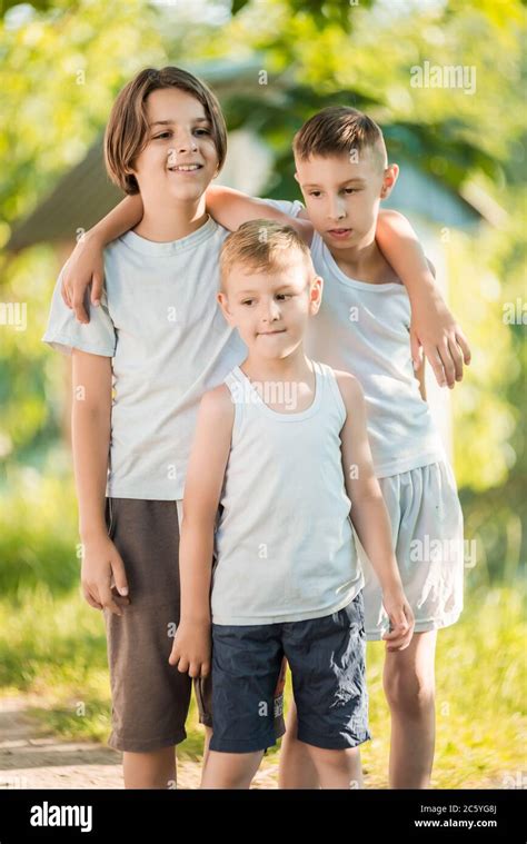 Three Happy Boys Posing Outside Stock Photo Alamy