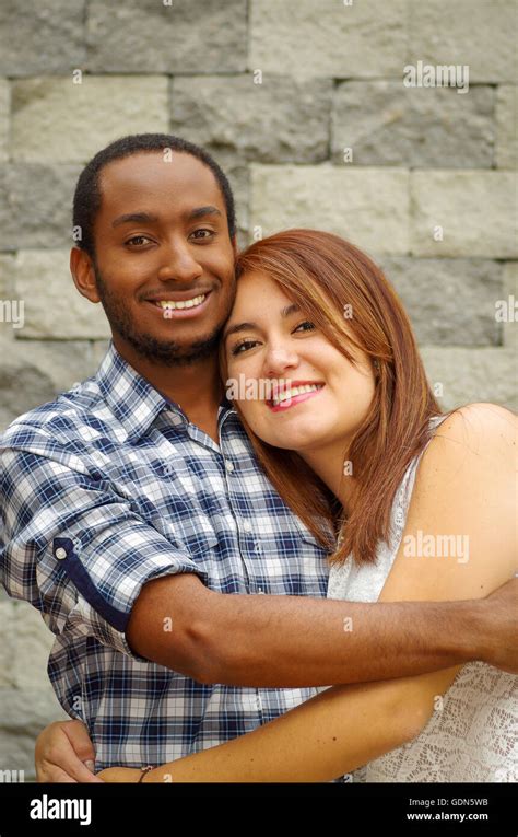 Interracial Charming Couple Wearing Casual Clothes Posing For Camera