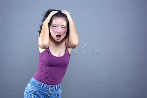 Young Chinese Brunette With Her Hands On Her Head In Shock Stock Image Image Of Dramatic Fear