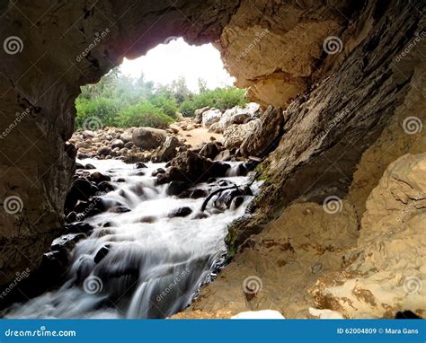 Entrance Of A Cave River With A Small Waterfall Into An Underground